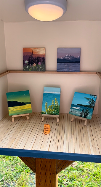 Mini paintings on easels inside gallery